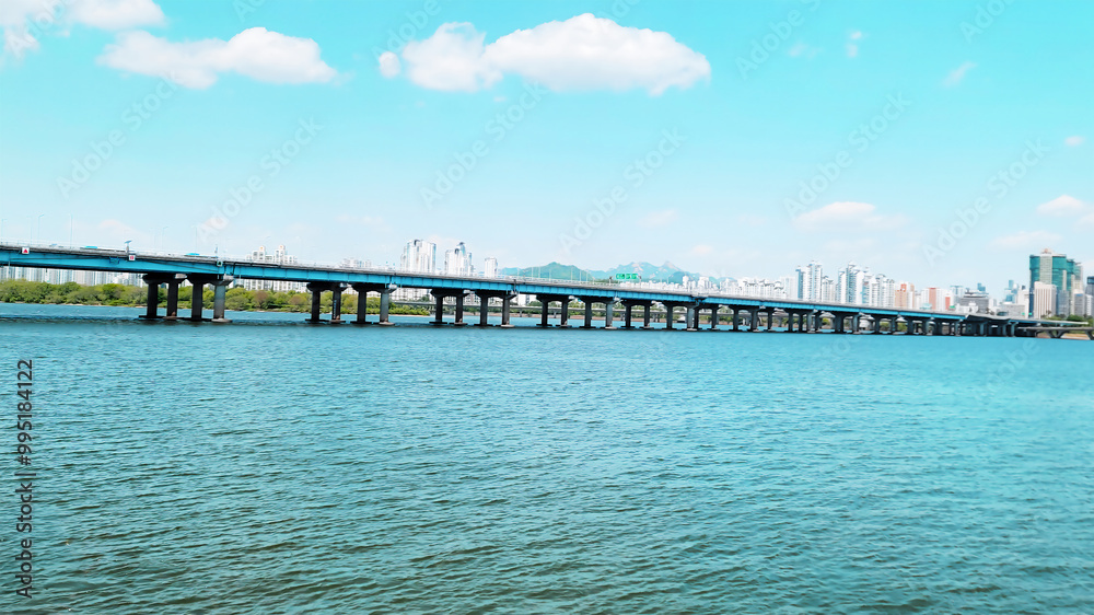 panorama view of the river, Yeouido Hangang River Park, in Seoul, Korea, with a broad bridge, and a cityscape in the backdrop
panorama view of the river, Yeouido Hangang River Park, in Seoul, Korea, with a broad bridge, and a cityscape in the backdrop