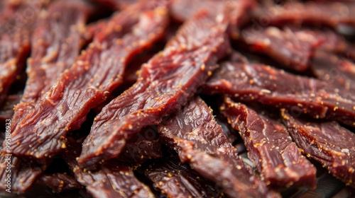 Jerky: Thin strips of dried meat, typically beef, packed with protein and seasoned with flavors like teriyaki or barbecue, perfect for a savory snack. 