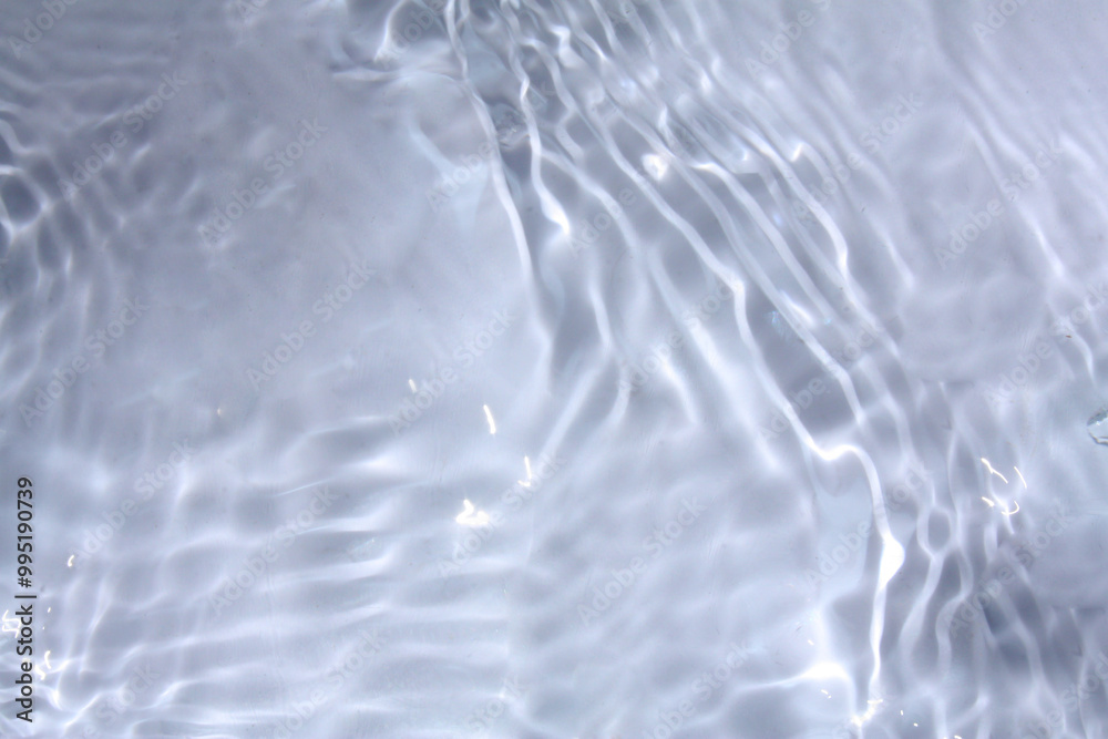 White water with ripples on the surface. Defocus blurred transparent white colored clear calm water surface texture with splashes and bubbles. Water waves with shining pattern texture background. White water with ripples on the surface. Defocus blurred transparent white colored clear calm water surface texture with splashes and bubbles. Water waves with shining pattern texture background.
