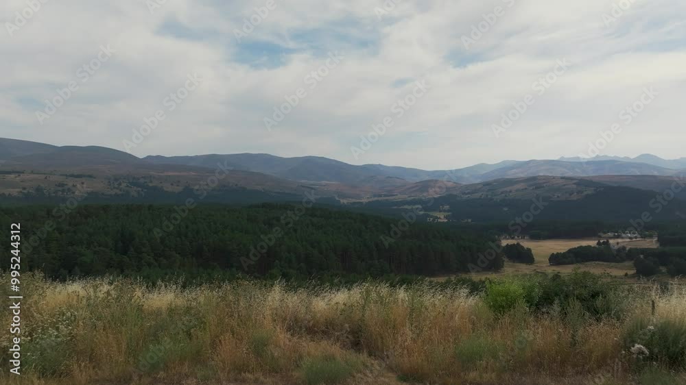 Frontal flight with a drone starting from a solid ground platform and we discovered a fascinating landscape of the Sierra de Gredos mountain system in Ávila with its lush forests, the sky has clouds Frontal flight with a drone starting from a solid ground platform and we discovered a fascinating landscape of the Sierra de Gredos mountain system in Ávila with its lush forests, the sky has clouds