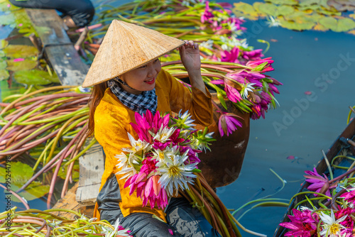 Wallpaper Mural view of rural Vietnamese girl in Moc Hoa district, Long An province, Mekong Delta are harvesting water lilies. Water lily is a traditional dish here. Torontodigital.ca
