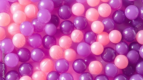 A copy space image featuring violet and pink plastic pellets