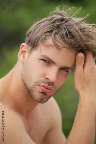 Portrait of the sexy young man outdoor. A Hipster guy model headshot. Male face. Young handsome man. Confident male model. Man looking proud. Closeup face of attractive man. Naked guy.