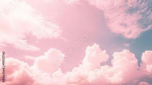 Pastel pink sky with cloud formations creating a natural backdrop ideal for textures wallpapers or card designs