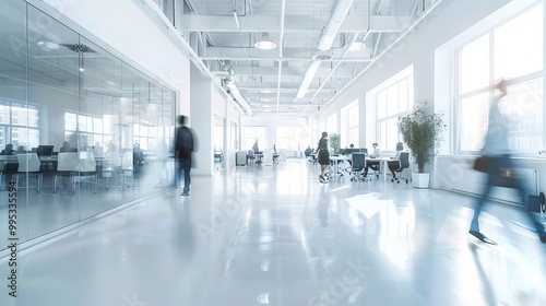 Blurred business office environment with white, light gray, and sky blue tones, featuring casually dressed professionals in a modern, open workspace.