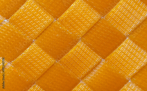 Orange woven plastic floor, slippery texture, orange plastic background, abstract background. photo