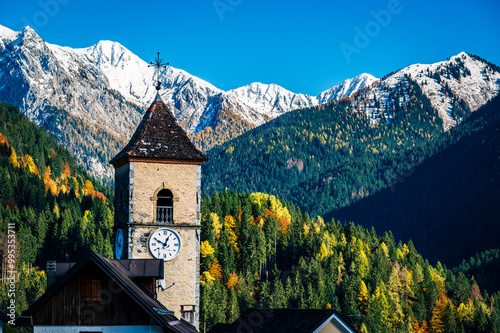 Autumn light on the Carnic Alps. Monte Coglians, Forni Avoltri and its colorful woods photo
