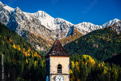 Autumn light on the Carnic Alps. Monte Coglians, Forni Avoltri and its colorful woods photo