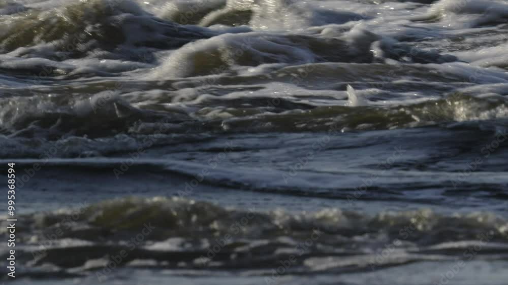Turbulent water with foamy waves, a river in motion Turbulent water with foamy waves, a river in motion