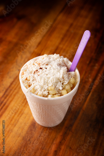 Esquites. Corn kernels cooked and served with mayo, sour cream, lemon and chili powder, very popular street food in Mexico, also known as Elote en Vaso. The recipe varies depending on the region.