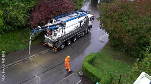 High angle view of sewer truck leaving after cleaning on a rainy autumn morning at Swiss City of Zürich. Movie shot September 26th, 2024, Zurich, Switzerland.