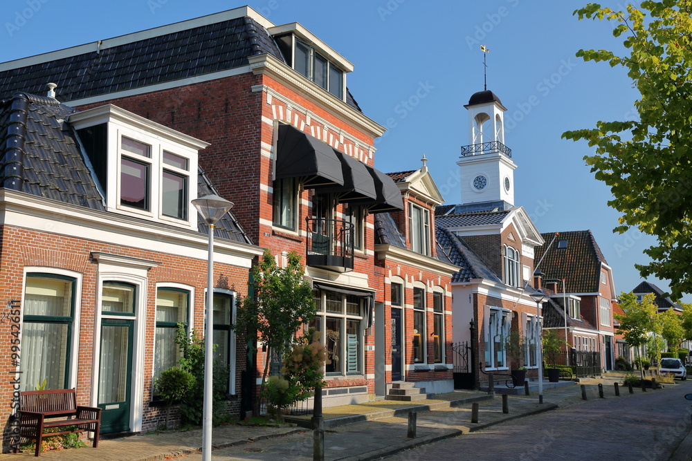 Traditional houses and a little church located along Legeweg street in the historic center of Dokkum, Friesland, Netherlands