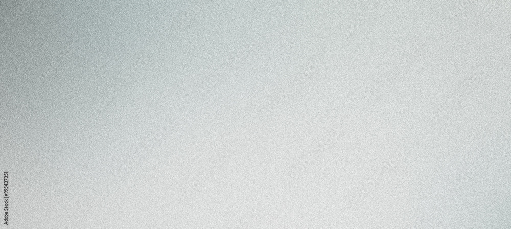 Grainy textured silver metallic background is reflecting light with a gradient effect Grainy textured silver metallic background is reflecting light with a gradient effect