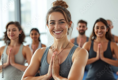 A yoga instructor leading a class with a serene smile in a close