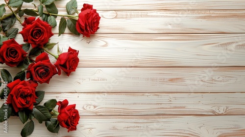 Fototapeta Naklejka Na Ścianę i Meble -  Sparse red roses in a corner on a light wooden background top view