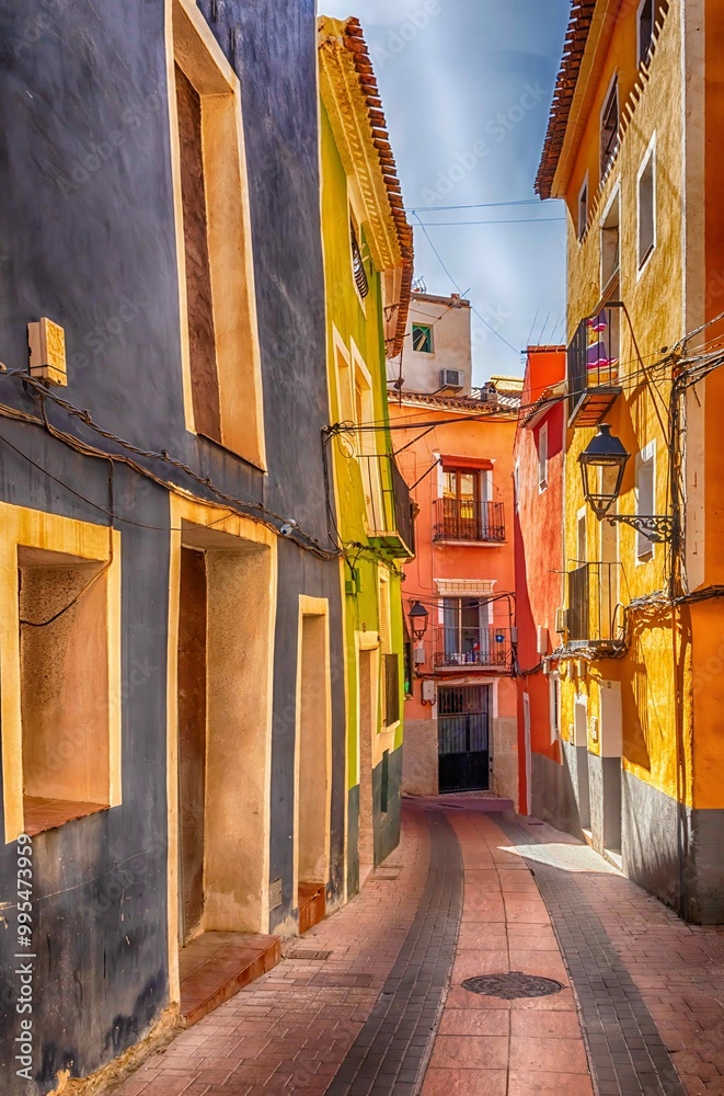 Fototapeta premium Narrow street of colourful houses in La Vela Joiosa, Costa Blanca, Spain