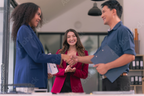 Business team shaking hands celebrating success Applause and shaking hands celebrating success in business deal Business people presenting their business start-up project together