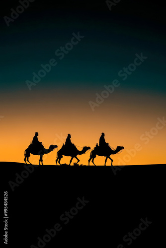 Silhouette of three wise men on camels at sunset