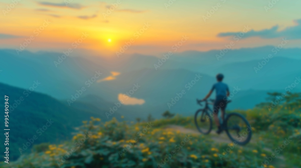 Blurred Silhouette of a Cyclist on a Mountain Trail as the Sun Rises Blurred Silhouette of a Cyclist on a Mountain Trail as the Sun Rises