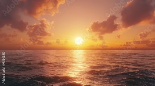 A beautiful sunrise over a tranquil ocean with the sun rising above the horizon.
