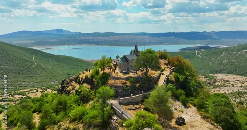 AERIAL: Crkva Na Valu Vracenovici church, sunny, summer day in Montenegro photo