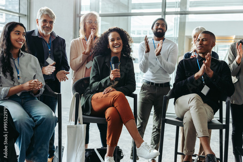 Картината върху платно Happy professionals enjoying a lively panel discussion at a corporate event