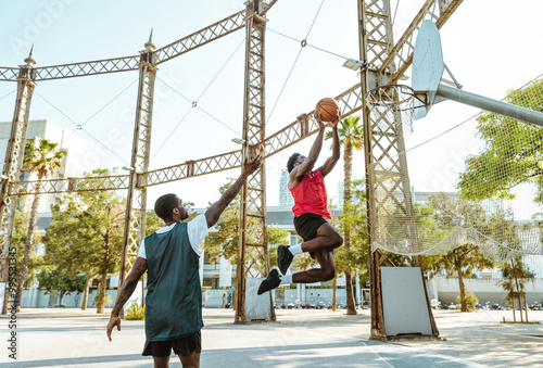 Young basketball players training at the court.