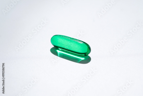 Vitamin E softgel capsules, vitamin D3, fish oil, omega 3, Green oil pills on a white background