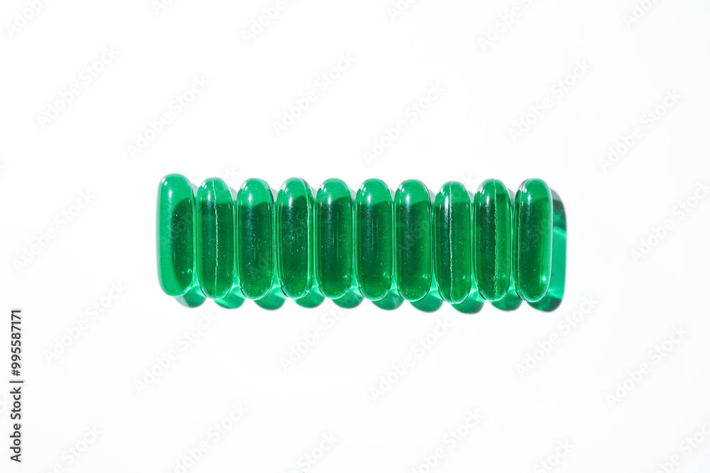 Vitamin E softgel capsules, vitamin D3, fish oil, omega 3, Green oil pills on a white background Vitamin E softgel capsules, vitamin D3, fish oil, omega 3, Green oil pills on a white background