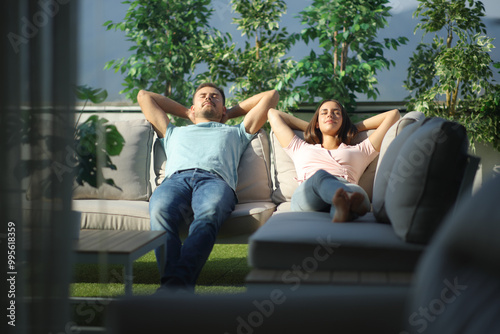Couple relaxing on a couch in a terrace