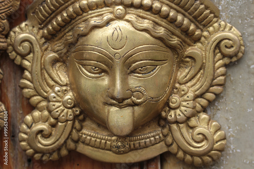 Bronze face of the Hindu goddess Kali or Durga. photo