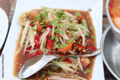 Papaya salad with fermented fish sprinkled with acacia seeds photo