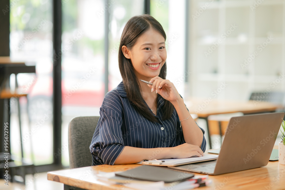 Asian business woman working happily at the office Asian business woman working happily at the office