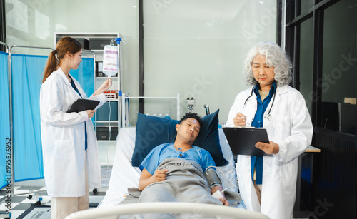 Professional doctor wear white coat uniform checking saline bag for patient at hospital room. Physician man care drip fluid saline bottle. Health care concept.