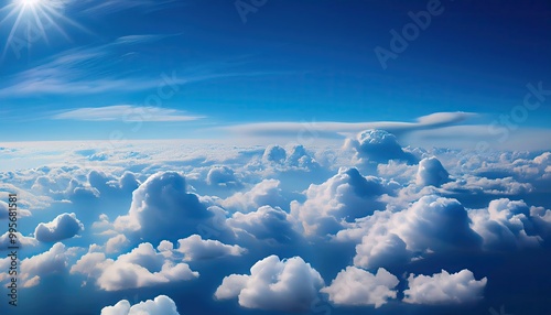 Fototapeta Naklejka Na Ścianę i Meble -  bright cloudy sky view from airplane. White clouds on blue sky background close up, cumulus clouds high in azure skies, beautiful aerial cloudscape view from above.