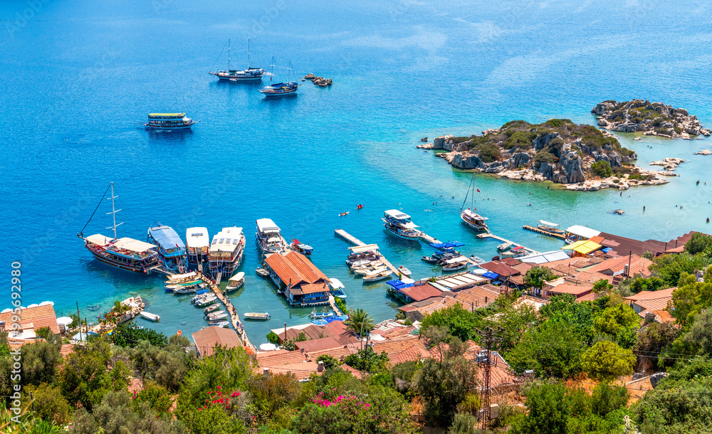 Obraz premium View over Kalekoy village and ruins of the Simena castle, with Kekova island across the water, in Antalya province of Turkey.