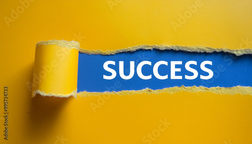 Torn yellow paper revealing the word SUCCESS against bright blue background.