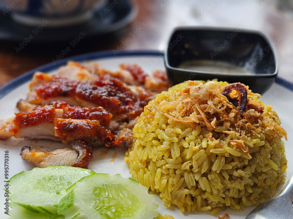 Thai southern style grilled chicken serving with biryani rice