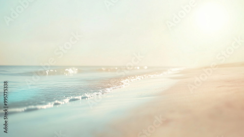 Soft out-of-focus image of an empty beach at sunrise with smooth waves and calm atmosphere
