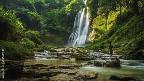 Sri Gethuk Waterfall cascades gracefully down the rocky cliffs at Oyo River, located in Menggoran Village, Yogyakarta Province, Central Java, Indonesia. photo