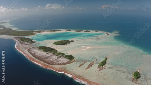 Breathtaking aerial perspective of Rangiroa island, the largest atoll in Tuamotus. Vibrant turquoise lagoon, intricate coral reefs, and abundant greenery. Remote untouched places, travel destination photo