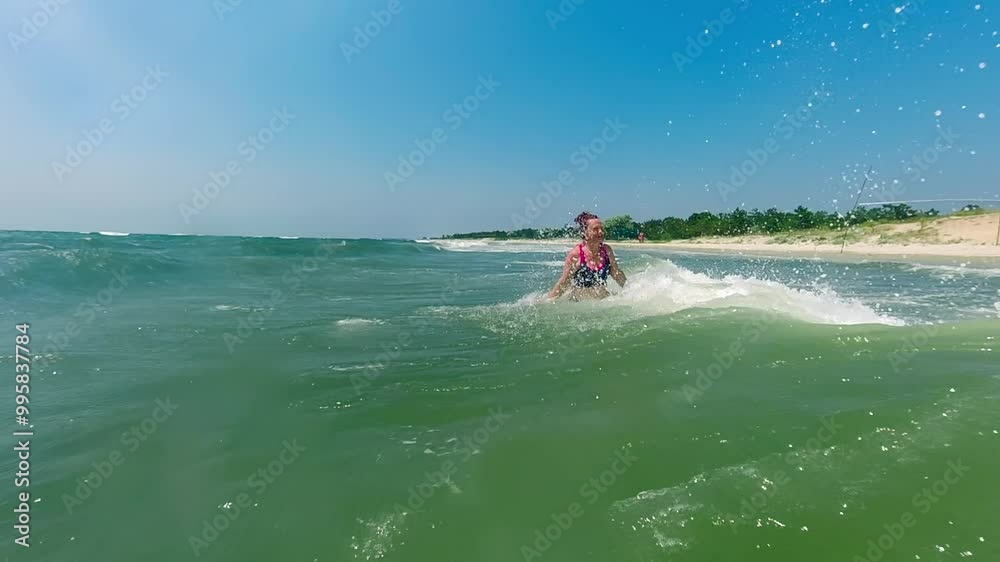Sunny Vacation Fun: Woman Enjoying the Rush of Big Sea Waves Sunny Vacation Fun: Woman Enjoying the Rush of Big Sea Waves