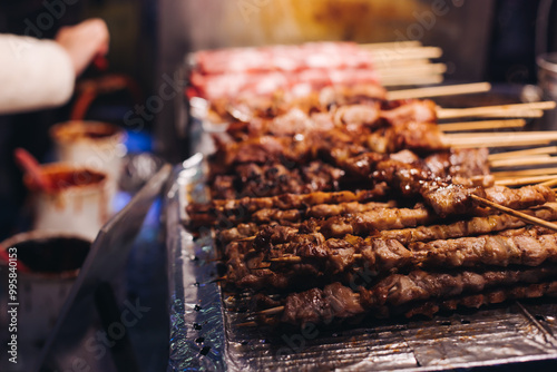 Korean barbecue, Ddakkochi, grilled chicken and pork skewers, variety of different traditional street food selection in Seoul, South Korea, night market with local vendor stalls cooking tasty dishes photo