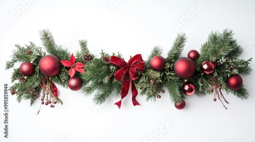 A festive holiday garland made of pine branches, ornaments, and ribbons, elegantly draped on a white background for Christmas decor.