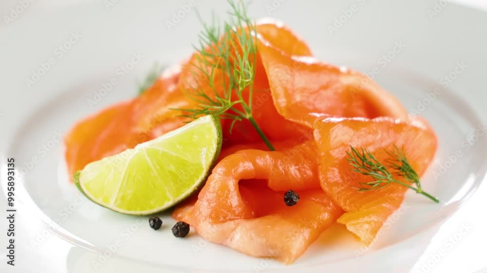 Thin slices of smoked salmon with lemon and dill on white background. Ideal for gourmet cuisine and healthy meal concepts Thin slices of smoked salmon with lemon and dill on white background. Ideal for gourmet cuisine and healthy meal concepts