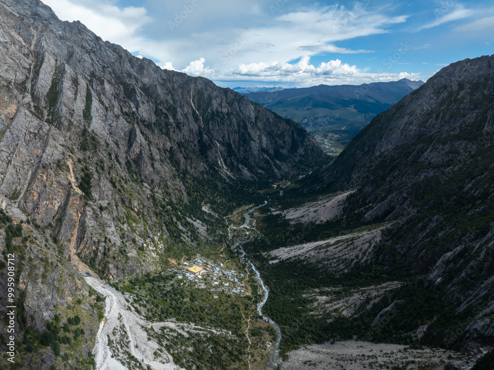 Aerial view of beautiful high altitude forest canyon and snow capped mountain landscape Aerial view of beautiful high altitude forest canyon and snow capped mountain landscape