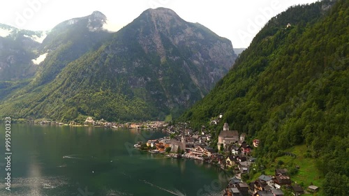 Aerial view of Hallstatt, Austria, captured by drone, showcasing its picturesque lakeside homes, majestic mountains, and the unique charm of this enchanting alpine village. photo