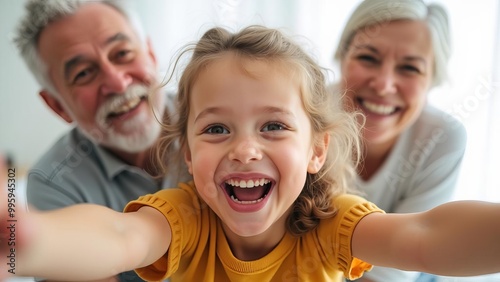 Excited Grandchild Taking Selfie with Grandparents: Joyful Multi-Generational Family Moment Captured in Vibrant Indoor Setting