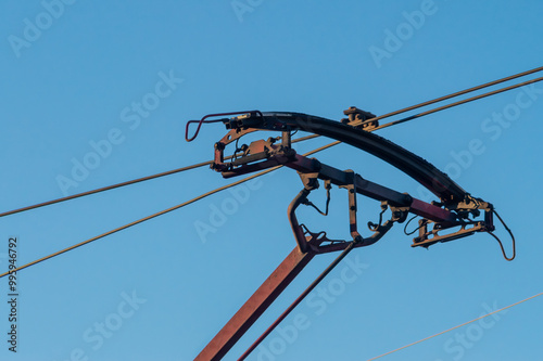 Close up of asymmetrical pantograph of the electrical pickup photo