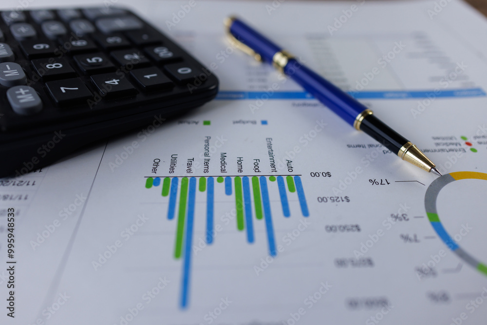 Business analyzing financial charts at desk, calculator and a pen to review data and make important business decisions
Business analyzing financial charts at desk, calculator and a pen to review data and make important business decisions